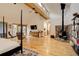 Living room featuring wood floors, fireplace, ceiling beams, and natural light with deck access at 2720 S Spring Gulch Rd, Idaho Springs, CO 80452