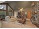 Inviting living room with stone fireplace, cozy seating, and large windows offering natural light at 2720 S Spring Gulch Rd, Idaho Springs, CO 80452