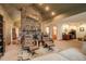 Spacious living room features a floor-to-ceiling stone fireplace and comfortable leather chairs at 2720 S Spring Gulch Rd, Idaho Springs, CO 80452