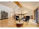Large main bedroom with vaulted ceilings, sitting area, wood floors, and natural light at 2720 S Spring Gulch Rd, Idaho Springs, CO 80452