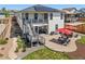 Beautiful backyard with patio, outdoor seating, lush lawn, and mature landscaping at 398 Midden Pl, Castle Rock, CO 80104