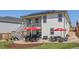 Well-maintained backyard with a patio, outdoor seating, and lush lawn at 398 Midden Pl, Castle Rock, CO 80104