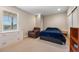 Relaxing bedroom featuring a cozy armchair, soft carpet, and plenty of natural light from the window at 398 Midden Pl, Castle Rock, CO 80104