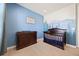 Sweet Bedroom featuring a dark wood crib and changing table against a serene mountain mural at 398 Midden Pl, Castle Rock, CO 80104