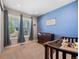Charming Bedroom with a blue accent wall, crib, and ample natural light from the large window at 398 Midden Pl, Castle Rock, CO 80104