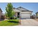 Attractive single-Gathering house with a tidy lawn, complemented by stone and siding details at 398 Midden Pl, Castle Rock, CO 80104