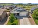 Charming home with a well-manicured lawn, stone accents, and a two-car garage at 398 Midden Pl, Castle Rock, CO 80104