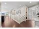 Hallway with white railing and dark wood floors leading to rooms with natural light at 398 Midden Pl, Castle Rock, CO 80104