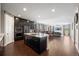 Open concept kitchen with island seating flows into the dining and living spaces at 398 Midden Pl, Castle Rock, CO 80104