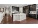 Modern kitchen boasts a large white quartz island and stylish dark cabinets at 398 Midden Pl, Castle Rock, CO 80104