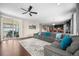 Open living space with a cozy sectional, access to an outdoor patio, and a seamless layout at 398 Midden Pl, Castle Rock, CO 80104