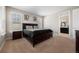Comfortable bedroom with a dark wood bed frame, natural light, and ensuite bathroom at 398 Midden Pl, Castle Rock, CO 80104