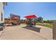 Expansive backyard patio featuring outdoor seating, a fire pit, and vibrant red umbrellas at 398 Midden Pl, Castle Rock, CO 80104