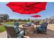 Inviting patio with a fire pit, seating, and umbrella, perfect for relaxing outdoors at 398 Midden Pl, Castle Rock, CO 80104