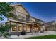 Rear exterior of home with a covered patio and a view of the lush green lawn at 4965 Malaya St, Denver, CO 80249