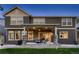 Back of home featuring a covered patio with outdoor seating and a well-maintained lawn at 4965 Malaya St, Denver, CO 80249