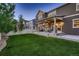 Expansive backyard with a covered patio, perfect for outdoor entertaining at 4965 Malaya St, Denver, CO 80249