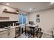 Basement bar features a wine refrigerator, sink, and table with chairs at 4965 Malaya St, Denver, CO 80249