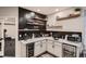 Modern basement bar with black subway tile and wooden floating shelves at 4965 Malaya St, Denver, CO 80249