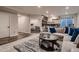Open basement features a sectional, coffee table, and access to the gym at 4965 Malaya St, Denver, CO 80249