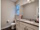 Bathroom featuring granite counters, white cabinets, and a window bringing in natural light at 4965 Malaya St, Denver, CO 80249