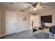 Bedroom features a ceiling fan, gray carpet, and a homework desk at 4965 Malaya St, Denver, CO 80249