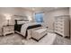 Bedroom with neutral paint, carpet, and natural light from the egress window at 4965 Malaya St, Denver, CO 80249