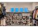 Organized walk-in closet featuring custom shelving and shoe storage at 4965 Malaya St, Denver, CO 80249