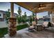 Covered patio area with cozy seating, ideal for relaxing and enjoying the backyard at 4965 Malaya St, Denver, CO 80249