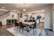 Dining area featuring wooden table, modern light fixture, adjacent to the kitchen and entryway at 4965 Malaya St, Denver, CO 80249