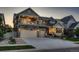 Stunning two-story home boasts stone accents, inviting balconies, and a spacious two-car garage with an expansive driveway at 4965 Malaya St, Denver, CO 80249