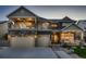 Charming two-story home featuring a spacious three-car garage and inviting front porch at 4965 Malaya St, Denver, CO 80249