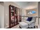 Hallway with a comfy chair and floor to ceiling glass displays at 4965 Malaya St, Denver, CO 80249
