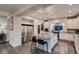 Stylish kitchen featuring a large granite island with seating, stainless steel appliances, and modern lighting fixtures at 4965 Malaya St, Denver, CO 80249