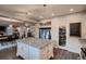 Well-appointed kitchen featuring a large island, modern appliances, walk-in pantry, and an open layout to dining area at 4965 Malaya St, Denver, CO 80249