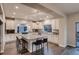 Contemporary kitchen with granite countertops, stainless appliances, ample cabinet space, and a large center island with seating at 4965 Malaya St, Denver, CO 80249