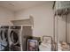 Modern laundry room with stainless steel appliances and a beverage cooler at 4965 Malaya St, Denver, CO 80249