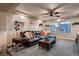 Cozy living room featuring modern ceiling fan and comfortable leather sofa and windows at 4965 Malaya St, Denver, CO 80249