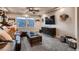 Comfortable living room features a ceiling fan, entertainment center, and a window at 4965 Malaya St, Denver, CO 80249