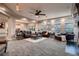 Spacious living room featuring neutral walls, ample seating, ceiling fan and an abundance of natural light at 4965 Malaya St, Denver, CO 80249