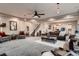 Bright and airy living room with plush carpet, neutral walls, adjacent stairway and open access to the kitchen at 4965 Malaya St, Denver, CO 80249