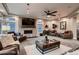 Inviting living room showcasing plush carpet, stone fireplace, comfortable seating, and large windows for natural light at 4965 Malaya St, Denver, CO 80249