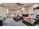 Spacious living room featuring a comfortable leather sofa and neutral decor with stairs in view at 4965 Malaya St, Denver, CO 80249