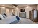 Main bedroom features a ceiling fan, tv, ensuite bathroom, and walk-in closet at 4965 Malaya St, Denver, CO 80249