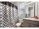 Bright bathroom with a stylish shower curtain, modern fixtures, and vanity with counter space at 23576 E 5Th Pl, Aurora, CO 80018