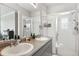 Bright bathroom features a double vanity and a glass-enclosed shower at 23576 E 5Th Pl, Aurora, CO 80018