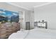 Bedroom featuring neutral walls, ensuite bathroom, and dresser storage at 23576 E 5Th Pl, Aurora, CO 80018
