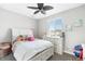 Cozy bedroom with a bright window, dresser, and decorative artwork at 23576 E 5Th Pl, Aurora, CO 80018