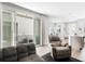 Open concept living area with a comfortable sofa and seamless access to kitchen and dining spaces at 23576 E 5Th Pl, Aurora, CO 80018