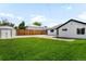 Large backyard features lush green lawn, wooden fence, and a convenient storage shed at 461 S Lowell Blvd, Denver, CO 80219